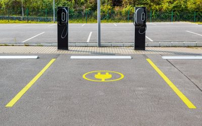 EV charging parking space with yellow lines and electric vehicle chargers in a lot - Line Striping King.
