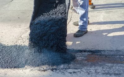 Excavating the old surface before fresh asphalt line striping.